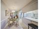 Bright dining area with a glass table and four chairs, adjacent to the kitchen at 1318 Leland Dr, Sun City Center, FL 33573
