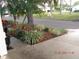 Neatly landscaped corner lot with mulch beds and greenery at 1318 Leland Dr, Sun City Center, FL 33573