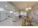 Kitchen features white cabinets, a breakfast bar, and a glass-top dining table at 1318 Leland Dr, Sun City Center, FL 33573