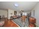 Spacious living room with hardwood floors, a ceiling fan, and built-in shelving at 1318 Leland Dr, Sun City Center, FL 33573
