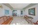 Cozy screened porch with wooden bench and small table, perfect for relaxing at 1318 Leland Dr, Sun City Center, FL 33573