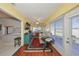 Bright sunroom features hardwood floors, large windows, and access to the outdoors at 1318 Leland Dr, Sun City Center, FL 33573
