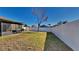 Fenced backyard with grassy area and screened patio at 1610 Bonita Bluff Ct, Ruskin, FL 33570