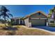 Single-story house with a two-car garage and palm trees at 1610 Bonita Bluff Ct, Ruskin, FL 33570