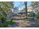 Landscaped backyard with brick path, shed and mature trees at 1745 E Mulberry Dr, Tampa, FL 33604
