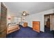 Bright bedroom with twin beds, dresser, and ceiling fan at 1745 E Mulberry Dr, Tampa, FL 33604
