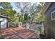 Wooden deck overlooking backyard with lush trees at 1745 E Mulberry Dr, Tampa, FL 33604