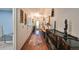 Long entry hallway with hardwood floors, a console table, and various decor items at 1745 E Mulberry Dr, Tampa, FL 33604