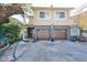 Front view of a two-story house featuring a double garage and a landscaped yard at 1745 E Mulberry Dr, Tampa, FL 33604