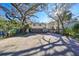 Two-story house with a double garage and a large driveway, surrounded by lush landscaping at 1745 E Mulberry Dr, Tampa, FL 33604