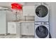 Laundry room with stackable washer/dryer and cabinets at 1745 E Mulberry Dr, Tampa, FL 33604