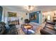 Living room with leather sofas, a coffee table, a large TV, and a ceiling fan at 1745 E Mulberry Dr, Tampa, FL 33604