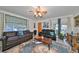 Living room with leather sofas, a coffee table, and large windows offering natural light at 1745 E Mulberry Dr, Tampa, FL 33604