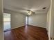 Spacious bedroom with wood-look floors and neutral walls at 1868 Monica Dr, Clearwater, FL 33763