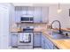 Modern kitchen with stainless steel appliances and light gray cabinets at 1885 Greenwood Valley Dr, Plant City, FL 33563