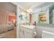 Bright bathroom featuring a vanity with decorative backsplash, adjacent to a bedroom at 19725 Gulf Blvd # 501, Indian Shores, FL 33785