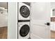 Compact laundry closet with stacked washer and dryer at 2 Adalia Ave # 502, Tampa, FL 33606