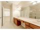 Double vanity bathroom with a large mirror and shower at 2044 Santa Catalina Ln Dr # 2044, Riverview, FL 33578