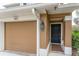 Townhome entry with two-car garage and black front door at 2044 Santa Catalina Ln Dr # 2044, Riverview, FL 33578
