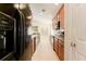 Modern kitchen with black appliances and wood cabinets at 2044 Santa Catalina Ln Dr # 2044, Riverview, FL 33578
