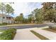 Residential street view with lush landscaping and pond at 2044 Santa Catalina Ln Dr # 2044, Riverview, FL 33578