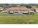 Back exterior view showing a home with screened patio and grassy backyard at 2315 New Orchard Ct, Sun City Center, FL 33573