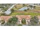 Community overview, showcasing villas near a pond and walking path at 2315 New Orchard Ct, Sun City Center, FL 33573