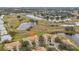 Aerial perspective of community villas, highlighting location near a pond at 2315 New Orchard Ct, Sun City Center, FL 33573
