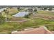 Community overview showcasing green spaces, walking paths, and a pond at 2315 New Orchard Ct, Sun City Center, FL 33573