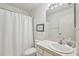 Clean bathroom with shower/tub combo, single sink vanity, and white tile at 2315 New Orchard Ct, Sun City Center, FL 33573