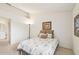 Bright bedroom with double bed, neutral decor, and access to bathroom at 2315 New Orchard Ct, Sun City Center, FL 33573
