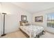 Cozy bedroom with a double bed, large window and neutral decor at 2315 New Orchard Ct, Sun City Center, FL 33573