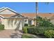 Tan villa with double garage and neatly trimmed hedges at 2315 New Orchard Ct, Sun City Center, FL 33573