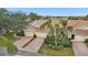 Tan two-story villa with attached garage and brick driveway at 2315 New Orchard Ct, Sun City Center, FL 33573