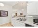 Simple kitchen with white cabinets and stainless steel appliances at 2315 New Orchard Ct, Sun City Center, FL 33573