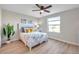 Bedroom featuring a comfortable bed, ceiling fan, and natural light from a large window at 2517 Edgewater Falls Dr, Brandon, FL 33511