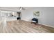 Open living room showcasing wood-look floors and kitchen at 272 Cypress Ln # 44, Oldsmar, FL 34677