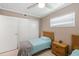 Cozy bedroom with twin beds, nightstand, and built-in closet at 3064 Pinetree St, Port Charlotte, FL 33952