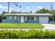 Ranch style home with a carport and a well-maintained lawn at 3064 Pinetree St, Port Charlotte, FL 33952