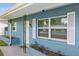 House exterior with blue siding, white shutters, and landscaping at 3064 Pinetree St, Port Charlotte, FL 33952
