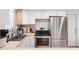 Modern kitchen with white cabinets, stainless steel appliances, and breakfast bar at 3064 Pinetree St, Port Charlotte, FL 33952