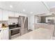 Modern kitchen with white cabinets, stainless steel appliances, and breakfast bar at 3064 Pinetree St, Port Charlotte, FL 33952