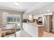 Modern kitchen with white cabinets, stainless steel appliances, and breakfast bar at 3064 Pinetree St, Port Charlotte, FL 33952