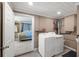 Convenient laundry room with washer, dryer, and extra storage at 3064 Pinetree St, Port Charlotte, FL 33952