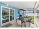 Screened patio with table and chairs, overlooking pool at 3064 Pinetree St, Port Charlotte, FL 33952