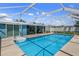 Relaxing screened pool with patio and backyard view at 3064 Pinetree St, Port Charlotte, FL 33952