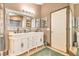 Elegant bathroom with double vanity, large mirror, and decorative tile at 309 Wood Dove Ave, Tarpon Springs, FL 34689