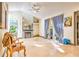 Sunlit living room with a fireplace, large windows and unique decor at 309 Wood Dove Ave, Tarpon Springs, FL 34689