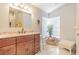 Updated bathroom with granite countertops, wood vanity and a comfortable seating area at 3127 Ivyhill Ct, Holiday, FL 34691