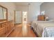Main bedroom with wood floors and access to en-suite bathroom at 3127 Ivyhill Ct, Holiday, FL 34691